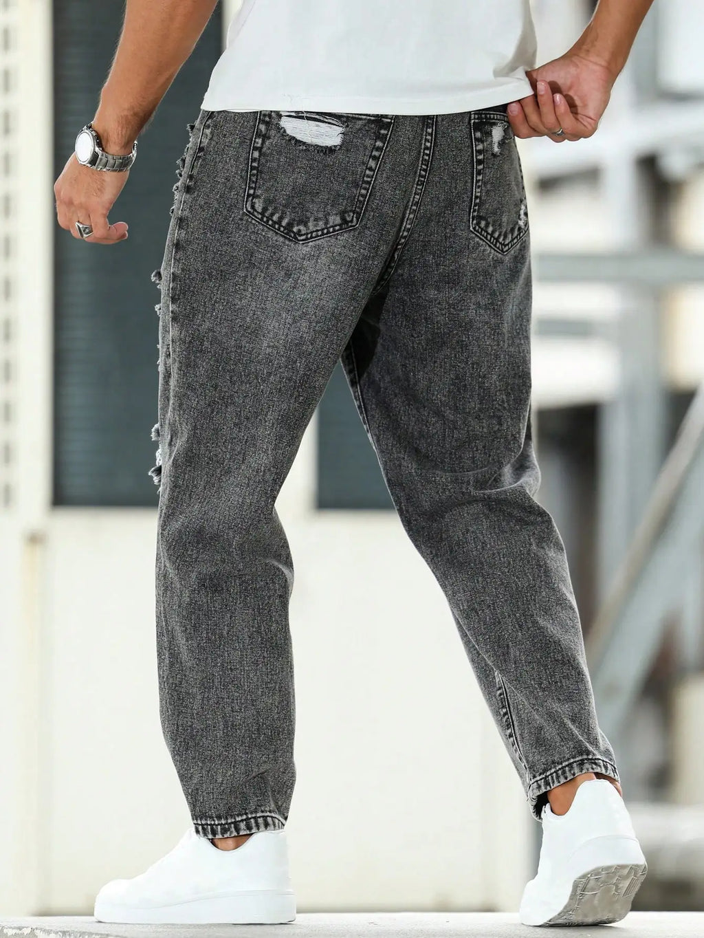Men's ripped jeans for spring and autumn, dark gray harem pants. Street style. Casual trend.