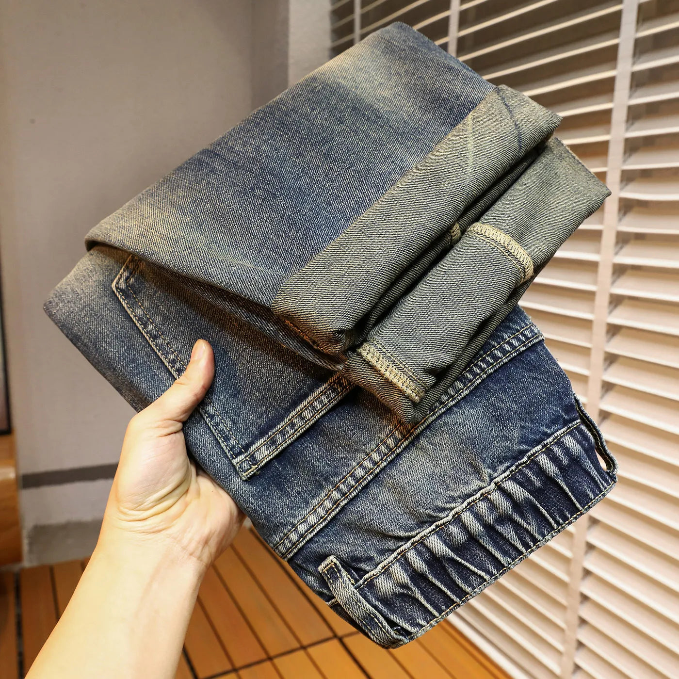 جينز رجالي أزرق عتيق مغسول بتصميم أمريكي بسيط وعصري، بقصة أرجل مستقيمة وفضفاضة، مريح.