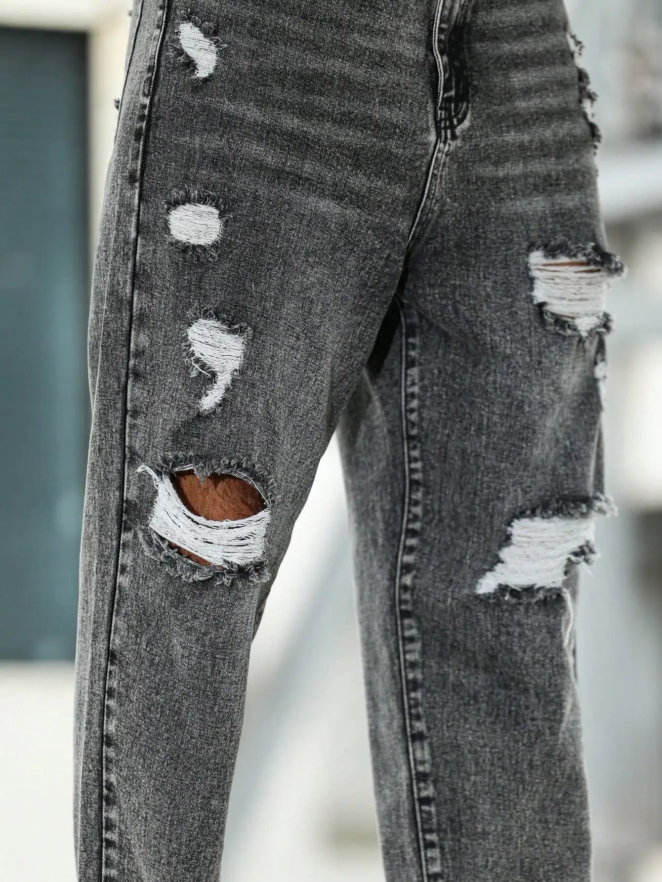 Men's ripped jeans for spring and autumn, dark gray harem pants. Street style. Casual trend.